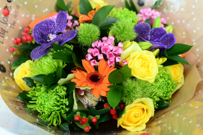 Vivacious - For a special occasion this beautiful bouquet will tick all the boxes. With its bright vibrant purple Vanda orchids and cheerful yellow roses, it also includes green shamrock blooms, hypericum berry and orange gemini. The design will have green foliage for support and contrast.