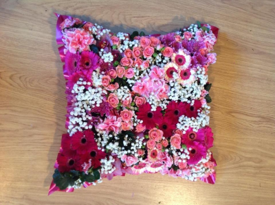 Pink and White Cushion - Pretty pink and white flowers are grouped together to create this design. The florist used gerberas, roses, gyp and spray roses along with complimenting foliage for best results. Flowers will be substituted depending upon availability. Colour choice can be changed upon request.