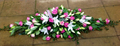Rose and Lily Funeral Spray. - White oriental lily's and pink roses with complimenting foliage was used to create this floral design. The rose and lily colour can be changed depending on preference, just use the special instructions box to tell us when placing the order.