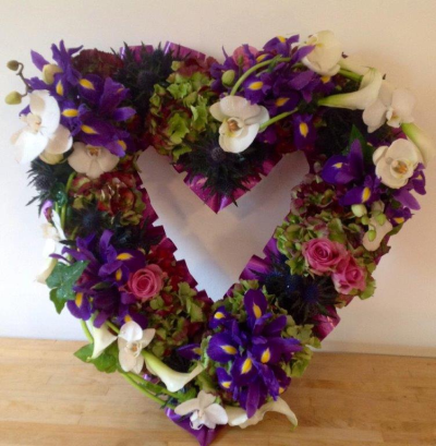 Open Heart Wreath Tribute - This heart wreath design has been made using orchids , iris, hydrangeas and roses. Depending upon availability we can change the flowers if not in season. Flowers and colours can b