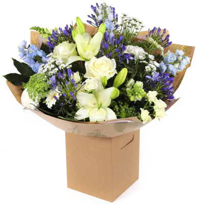 Ocean Bliss - A luxurious bouquet in shades of blue and white, featuring roses and lilies. Hand-tied and elegantly wrapped — perfect for serene, thoughtful gifting.