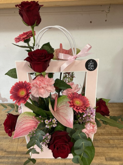 Get Carried away - Selection of flowers cascading out of this handbag style packaging. Lily Jones Flowers deliver in Birmingham and the Jewellery Quarter. Same day delivery is available.Flowers and colours can be changed on order, by adding it into the special request box.